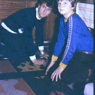 Two people playing board game indoors.