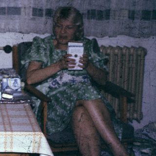 Three people sitting indoors, engaged in conversation.