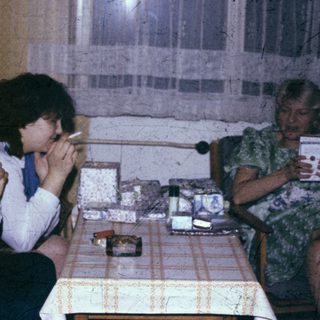 Three people sitting indoors, engaged in conversation.