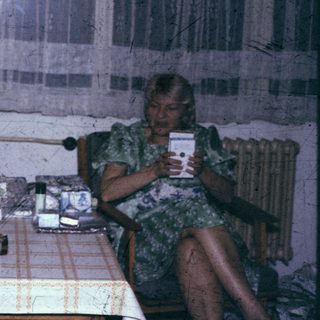 Three people sitting indoors, engaged in conversation.
