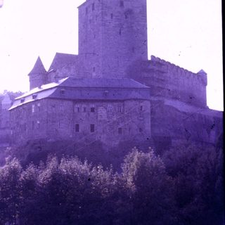 Medieval castle with tall tower and fortified walls.