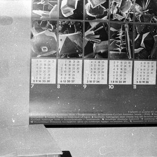 Black-and-white lunar calendar with moon phase illustrations.