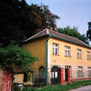 Yellow two-story building with aged exterior.