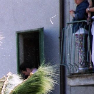 Traditional festival with tall, decorated straw giants.