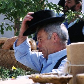 Traditional market scene with man handling basket of bread.