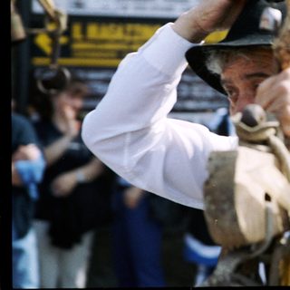 Man participating in traditional bull-rope twisting event.
