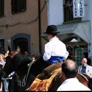Traditional equestrian procession in a town square.