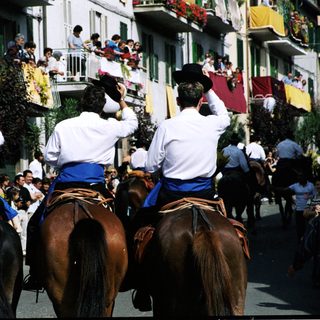 Traditional equestrian procession with riders in formal attire.