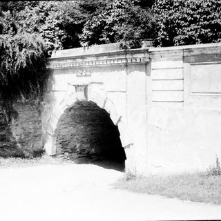 Architectural stone tunnel or archway in old wall.