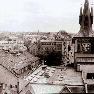 Historic European town square with clock tower.