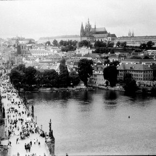 Historic Charles Bridge with Prague Castle in background.