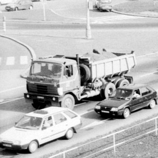 Traffic jam with construction vehicle on highway.