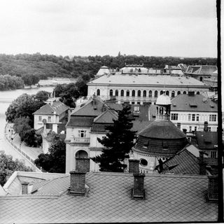 Historic European cityscape by river with bridges.