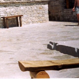 Rustic stone buildings with traditional outdoor altar.