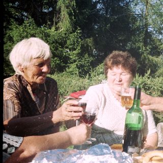 People enjoying drinks outdoors at a picnic.