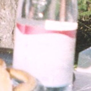 People enjoying drinks outdoors at a picnic.