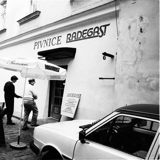 "Black-and-white street scene outside Pivnice Radegast beer hall."