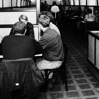 Underground café with patrons dining and staff serving.