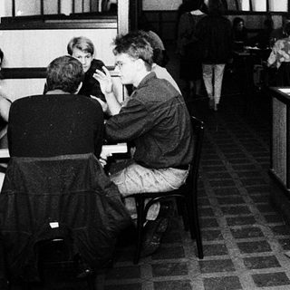 Underground café or bar with patrons seated.