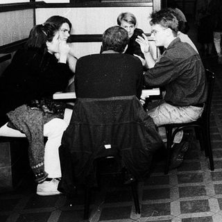 Underground café or bar with patrons seated.