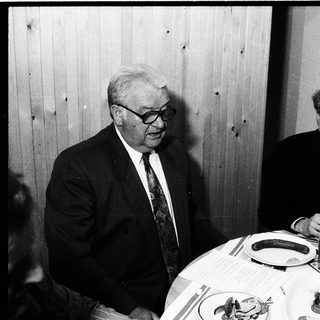 Two men dining together indoors.