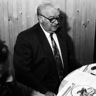 Two men dining together indoors.