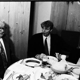 Two men dining together indoors.
