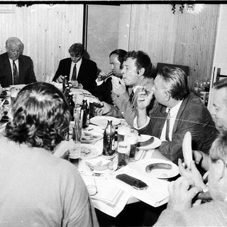 Business meeting or formal gathering with people seated at tables.