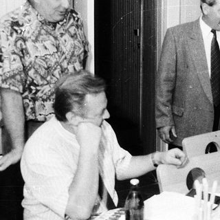 Group of people gathered indoors, likely at a formal dinner or meeting.
