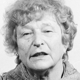 Portrait of an elderly woman wearing a scarf.
