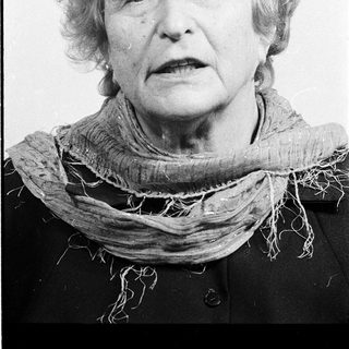 Portrait of an elderly woman wearing a scarf.