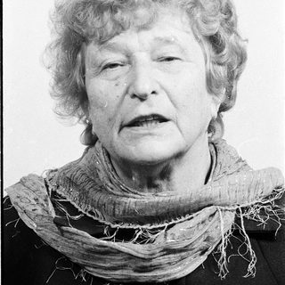 Portrait of an elderly woman wearing a scarf.