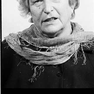 Portrait of an elderly woman wearing a scarf.