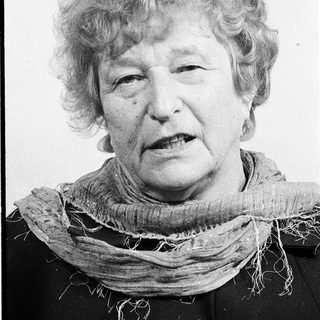 Portrait of an elderly woman wearing a scarf.