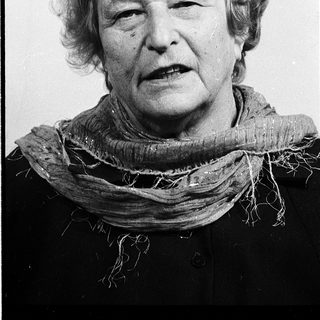 Portrait of an elderly woman wearing a scarf.