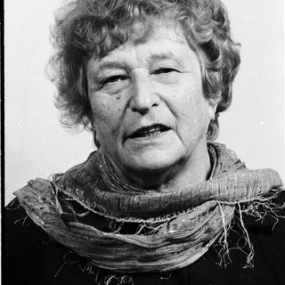 Portrait of an elderly woman wearing a scarf.