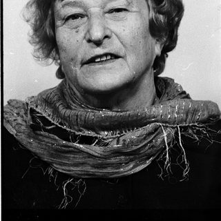 Portrait of an elderly woman wearing a scarf.
