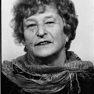 Portrait of an elderly woman wearing a scarf.