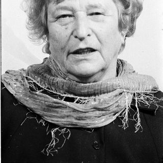 Portrait of an elderly woman wearing a scarf.