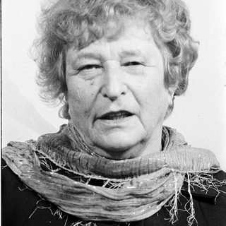 Portrait of an elderly woman wearing a scarf.