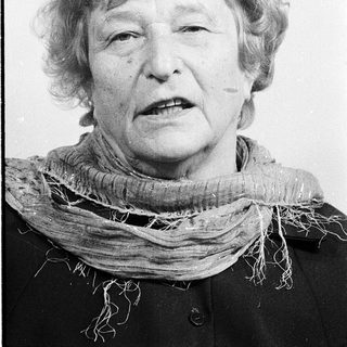 Portrait of an elderly woman wearing a scarf.
