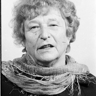 Portrait of an elderly woman wearing a scarf.