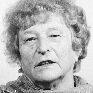 Portrait of an elderly woman wearing a scarf.