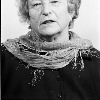 Portrait of an elderly woman wearing a scarf.