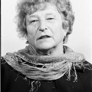 Portrait of an elderly woman wearing a scarf.