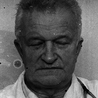 Older man in medical coat with stethoscope.