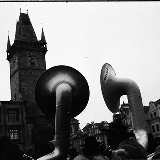 Historical protest with megaphones in front of clock tower.