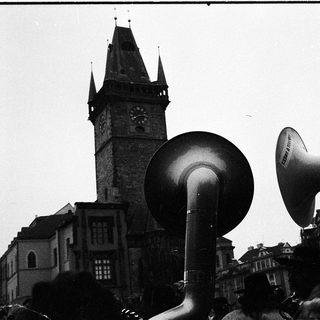 Historical protest with megaphones in front of clock tower.