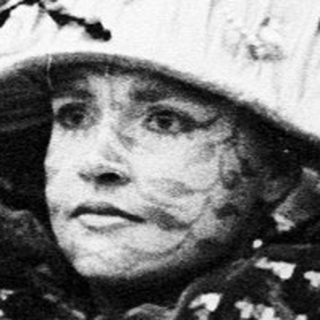 Costumed women in festive hats at parade.