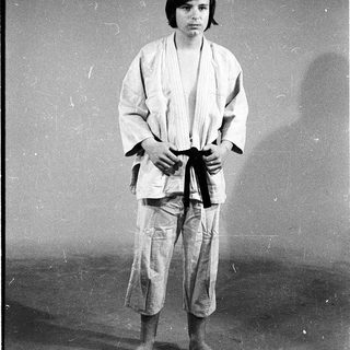 Person in traditional judo attire standing in stance.